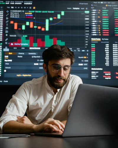 Business analyst reviewing comprehensive market data analytics