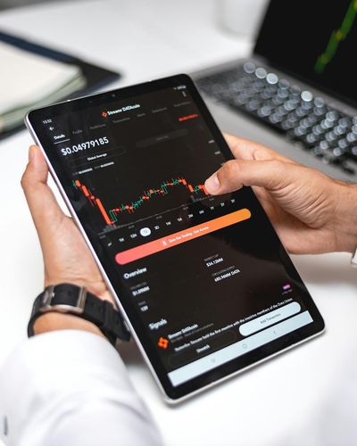 Young professional managing investment portfolio on smartphone